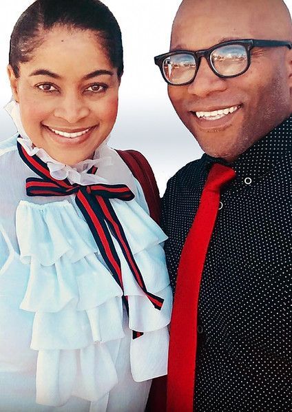 A man and a woman are posing for a picture and smiling