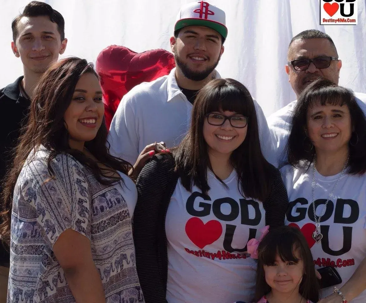 A group of people wearing god loves you shirts
