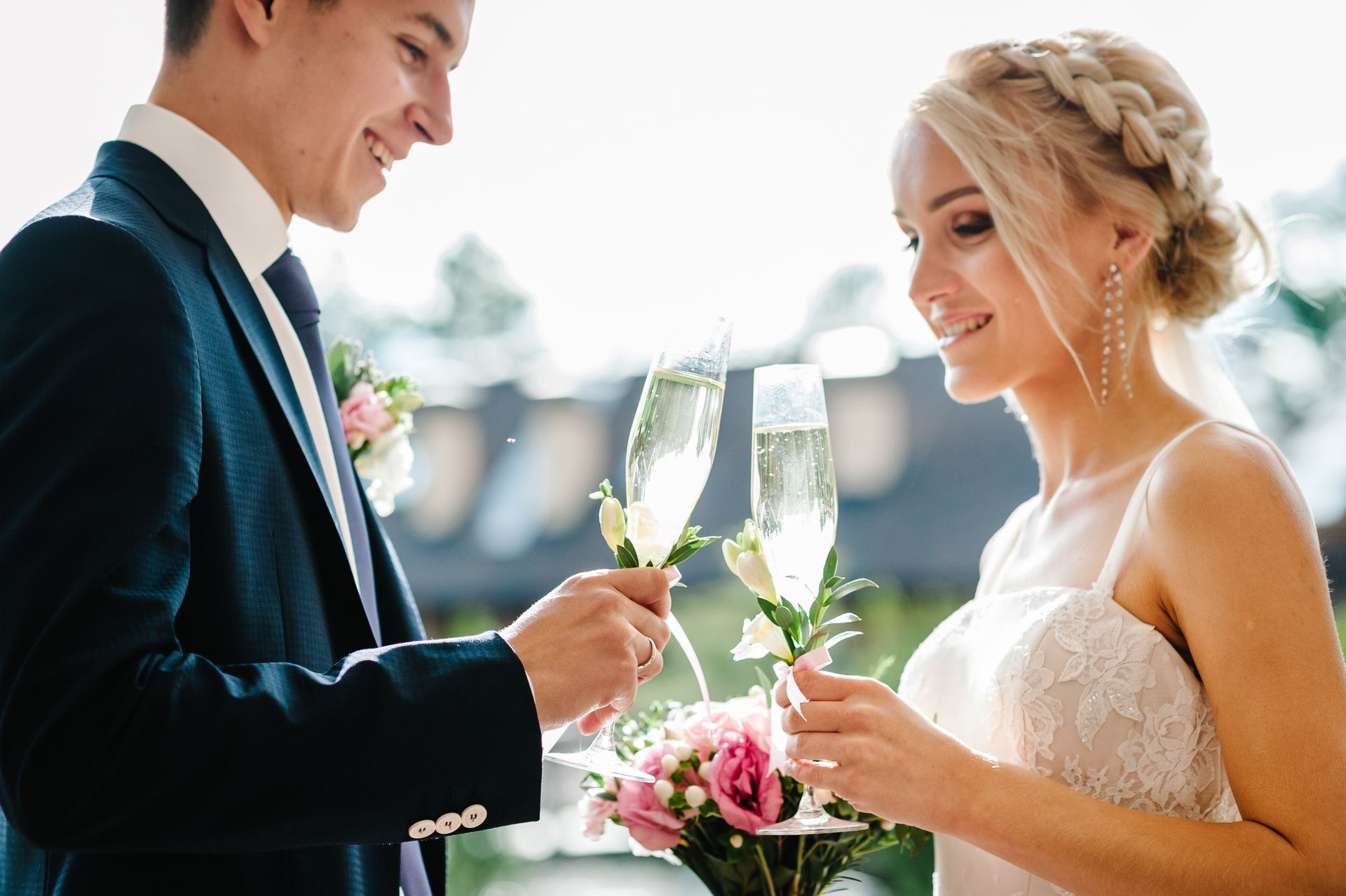 Bride and groom toasting champagne in decorative flutes on their wedding day at The Barn at Belle Hills