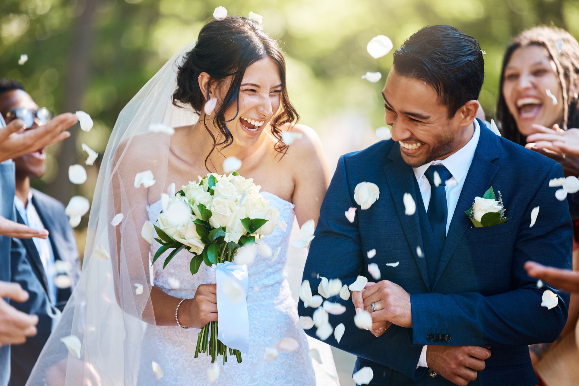 A bride and groom are walking down the aisle at their wedding.