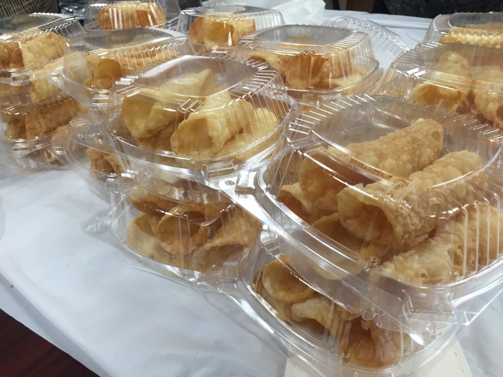 Plastic containers filled with crispy, golden pastries.