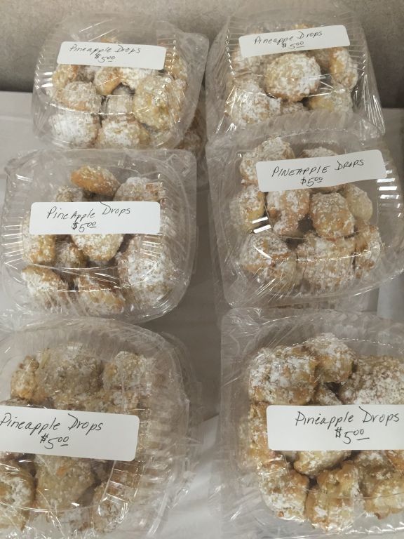 Plastic containers of powdered pineapple drops.