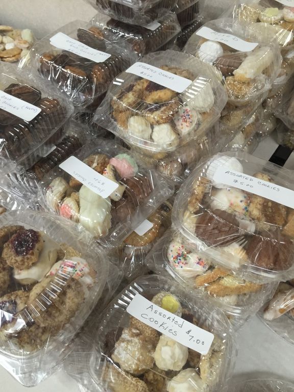 Assorted cookies in clear plastic containers.