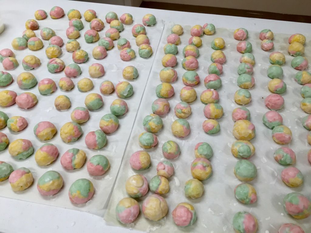 Rows of colorful, round pastries.