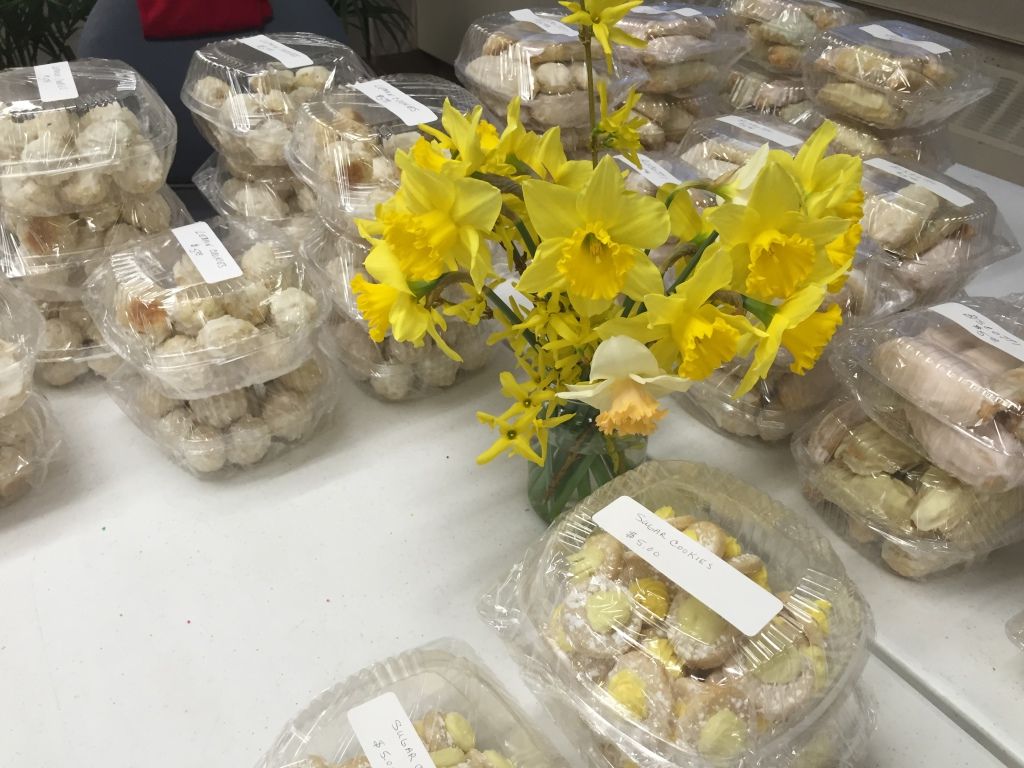 A table covered with trays of packaged cookies. 