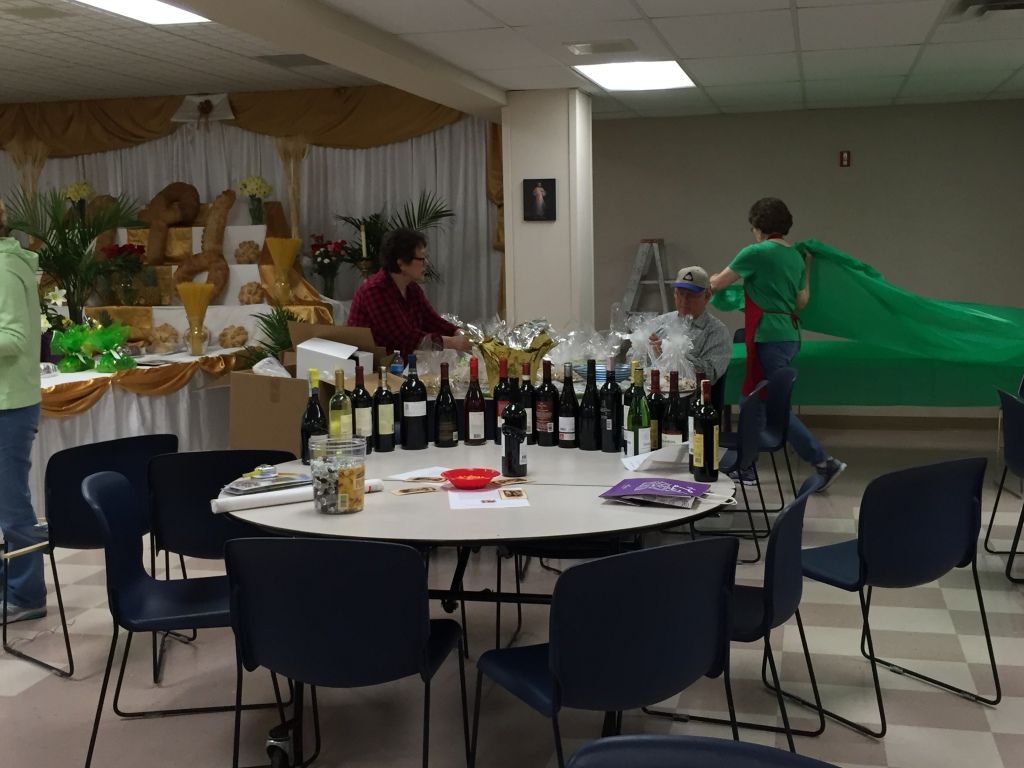 A table is set with various wine bottles and snacks.