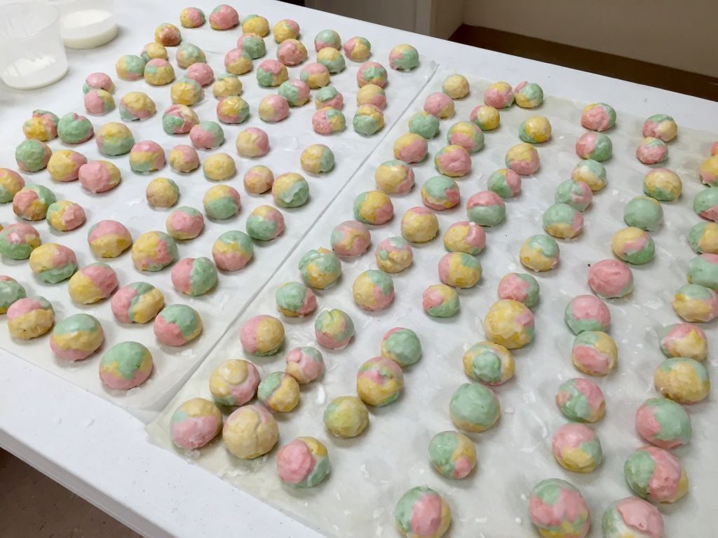 Rows of colorful, round pastries.