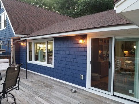 Deck with beautiful new dark blue shake vinyl siding installed for customer.