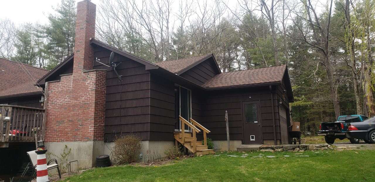 Customer in Blandford Massachusetts with wooden shake siding painted brown.