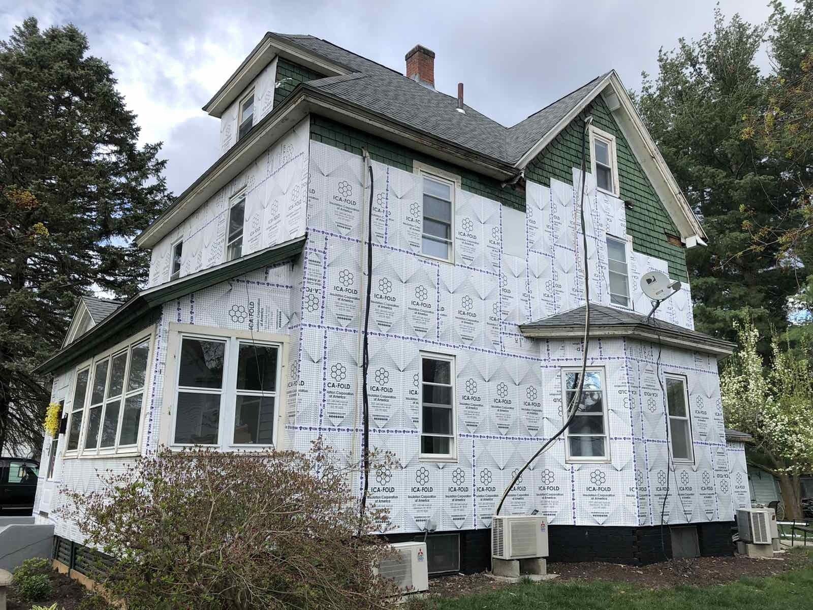 Old green siding has gone. New insulation and siding going on.