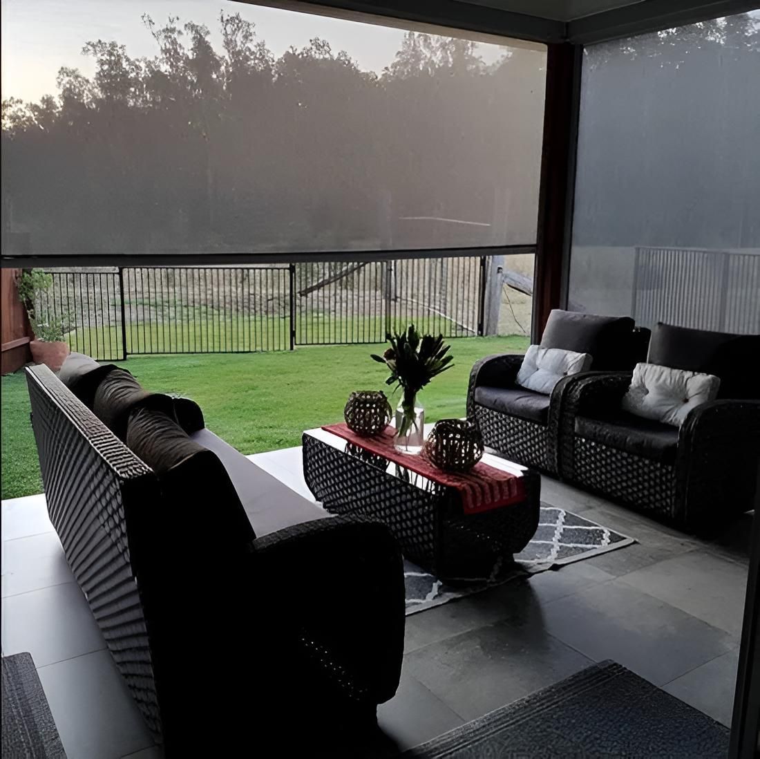 A Living Room With a Couch and Chairs and a Sliding Glass Door — Port Blinds & Awnings In Port Macquarie, NSW