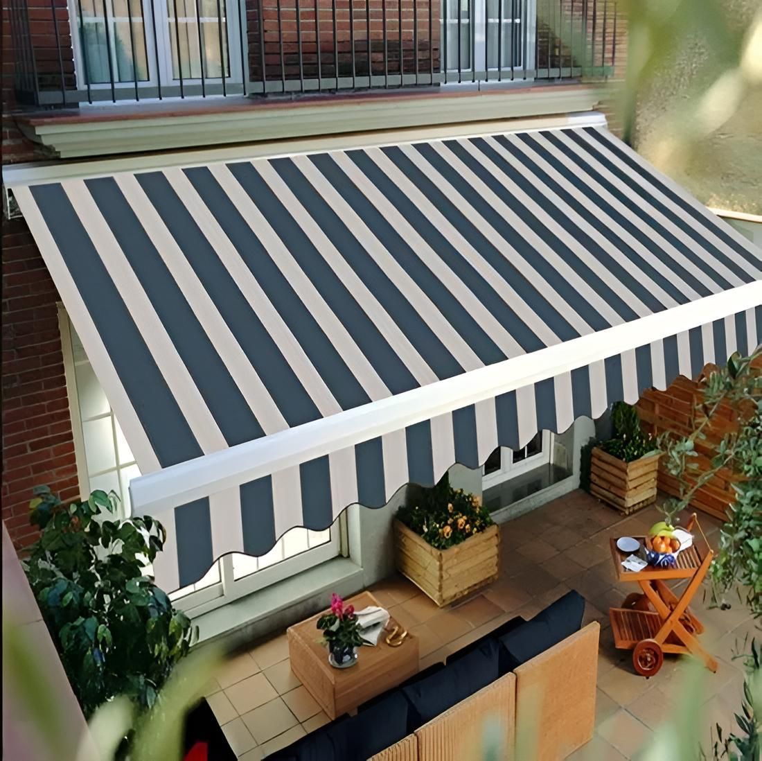 A Black and White Striped Awning Over a Patio — Port Blinds & Awnings In Port Macquarie, NSW