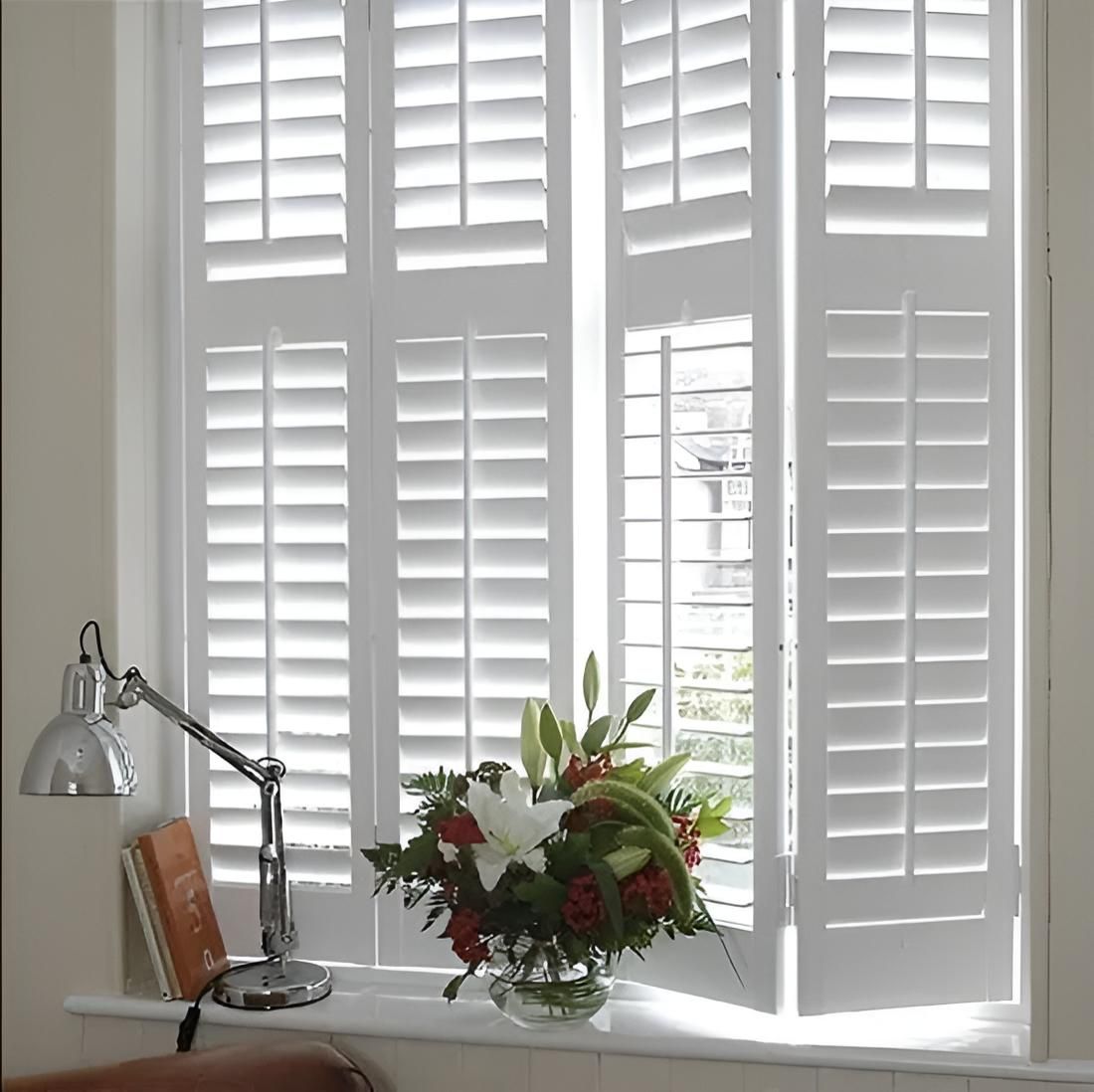 A Living Room With a Chair a Lamp and a Clock on the Wall — Port Blinds & Awnings In Port Macquarie, NSW