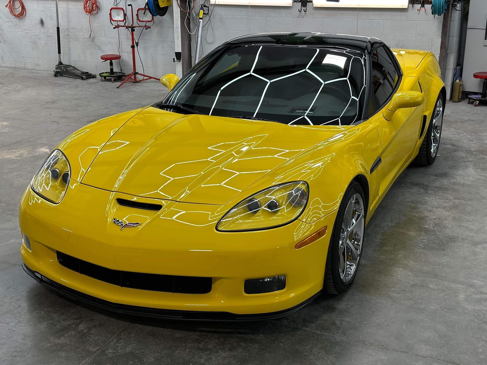 Yellow Corvette sports car in a garage,