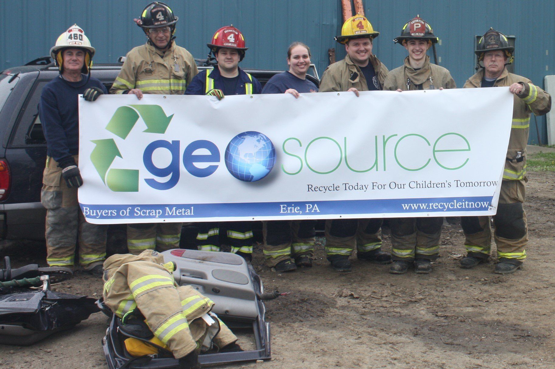 A group of firefighters holding a sign that says geosource