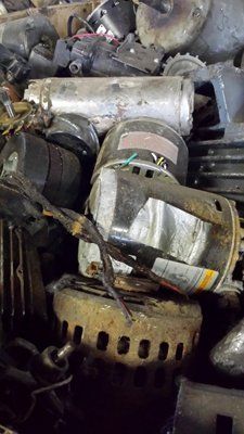 A pile of old motors sitting on top of each other.