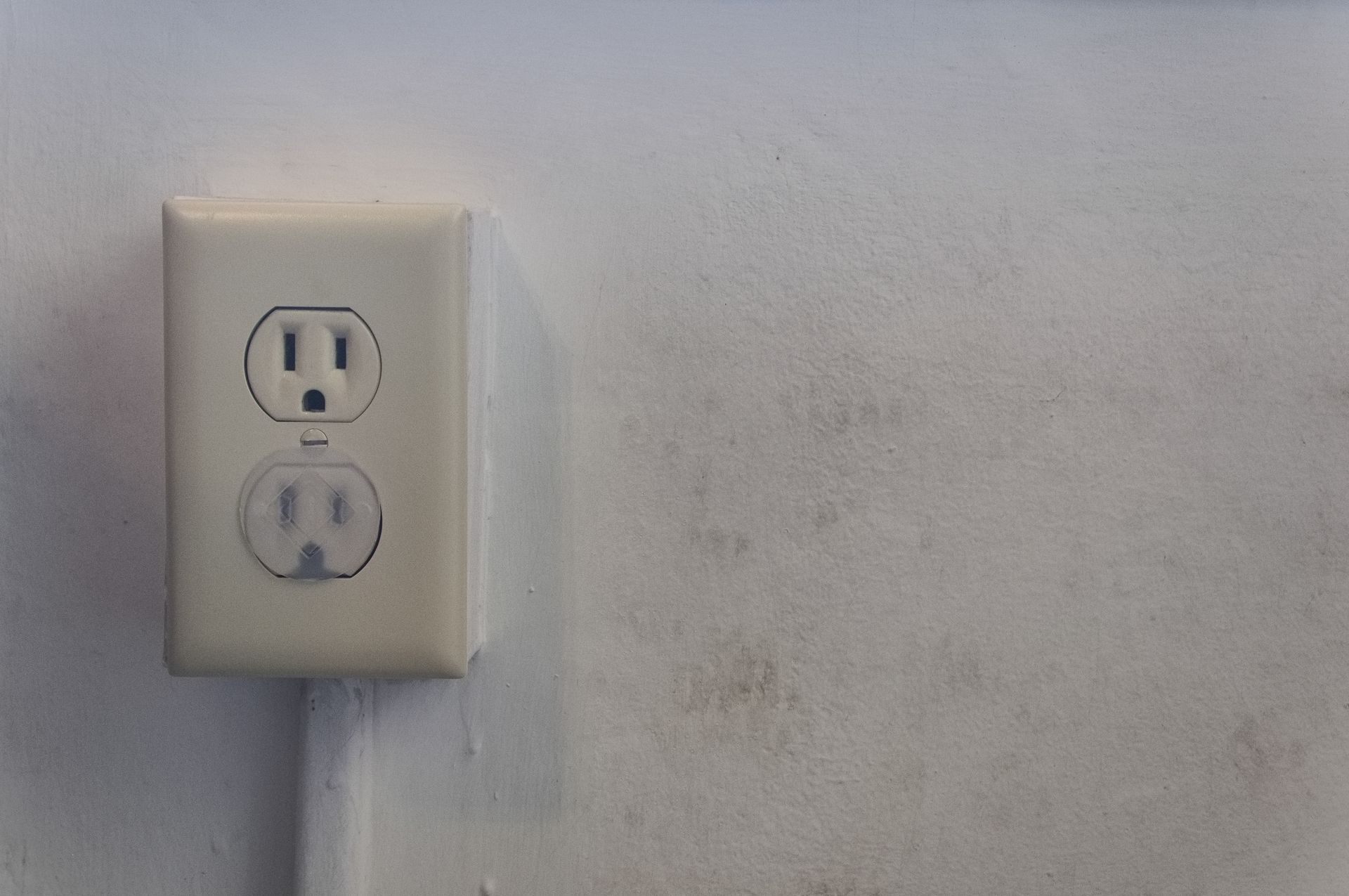 White electrical outlet on a white wall.