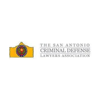 Logo for The San Antonio Criminal Defense Lawyers Association, with a yellow badge emblem and gray text