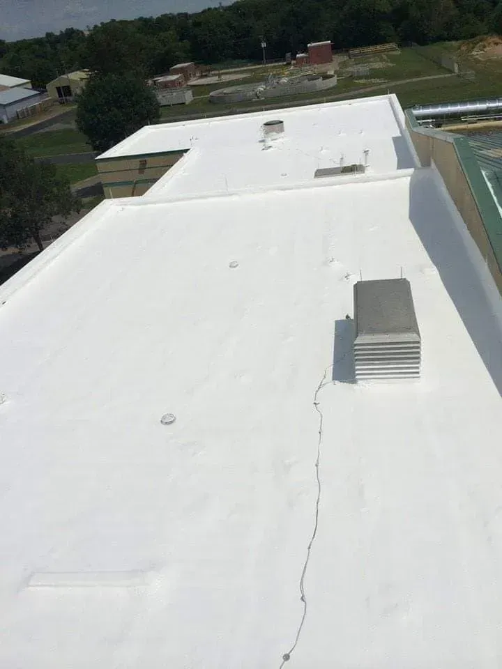 A white roof with a chimney on top of it.