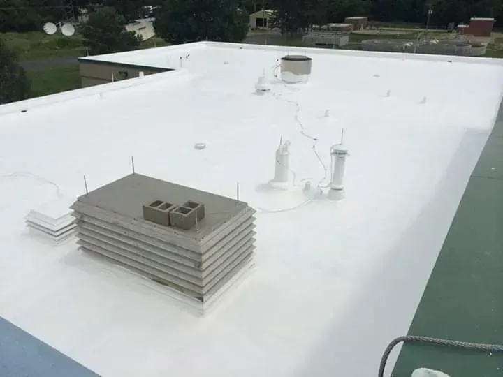 A white roof with a chimney on top of it.
