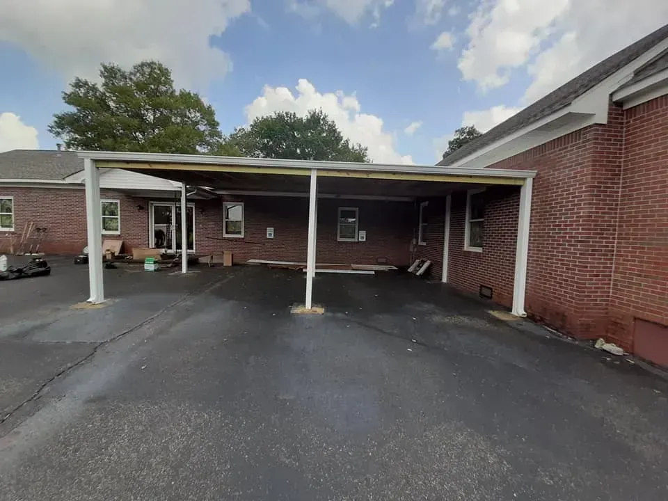 A brick house with a carport in front of it