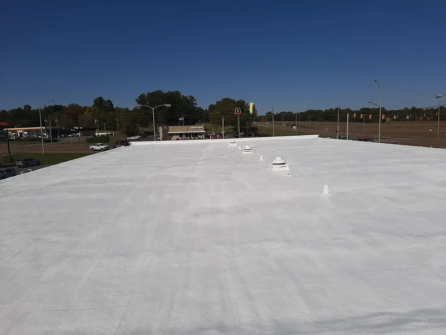 A large white roof with a blue sky in the background.