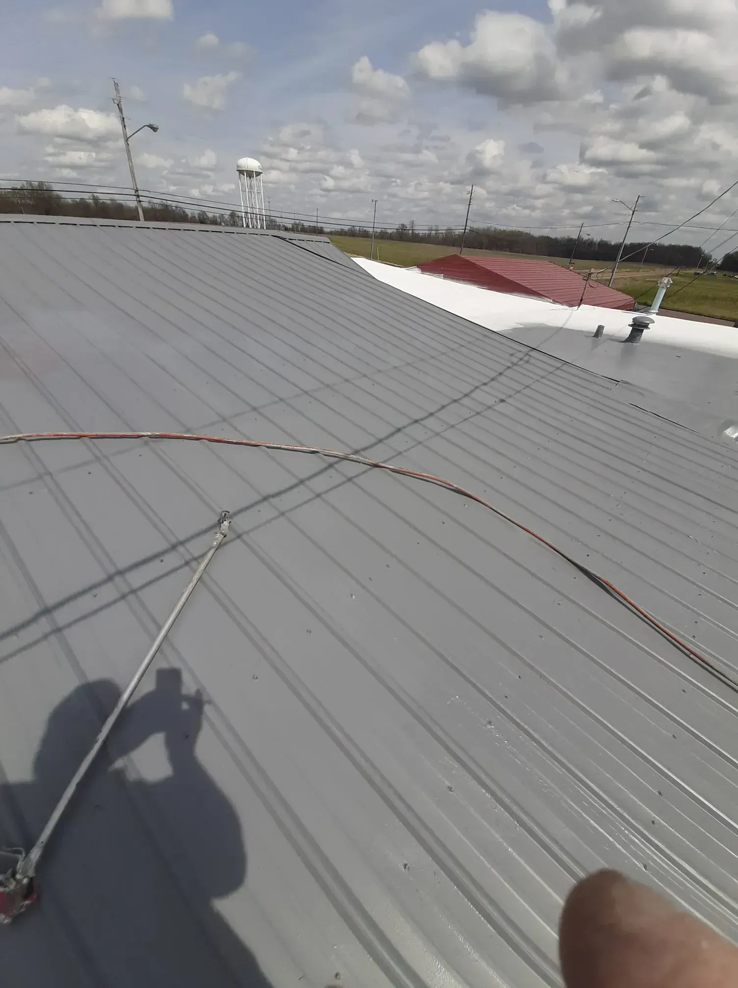 A person is standing on the roof of a building.