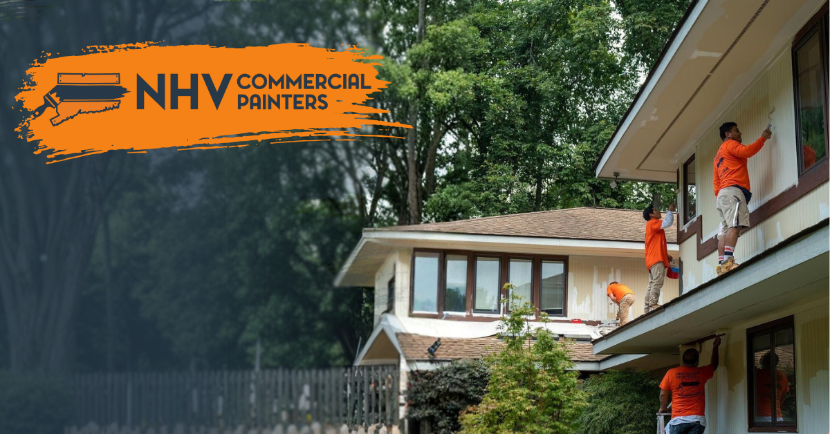 Four people in orange shirts paint the exterior of a white multi-story house near trees; New Haven Painters LLC logo.