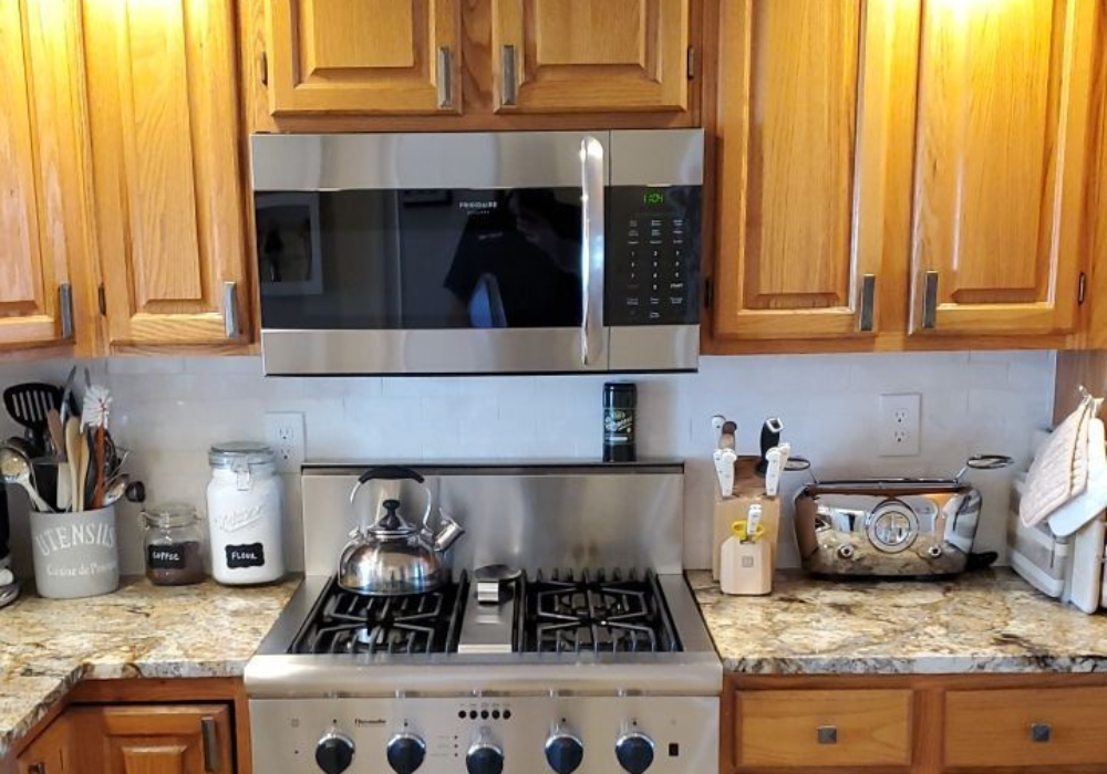 A kitchen with stainless steel appliances and wooden cabinets
