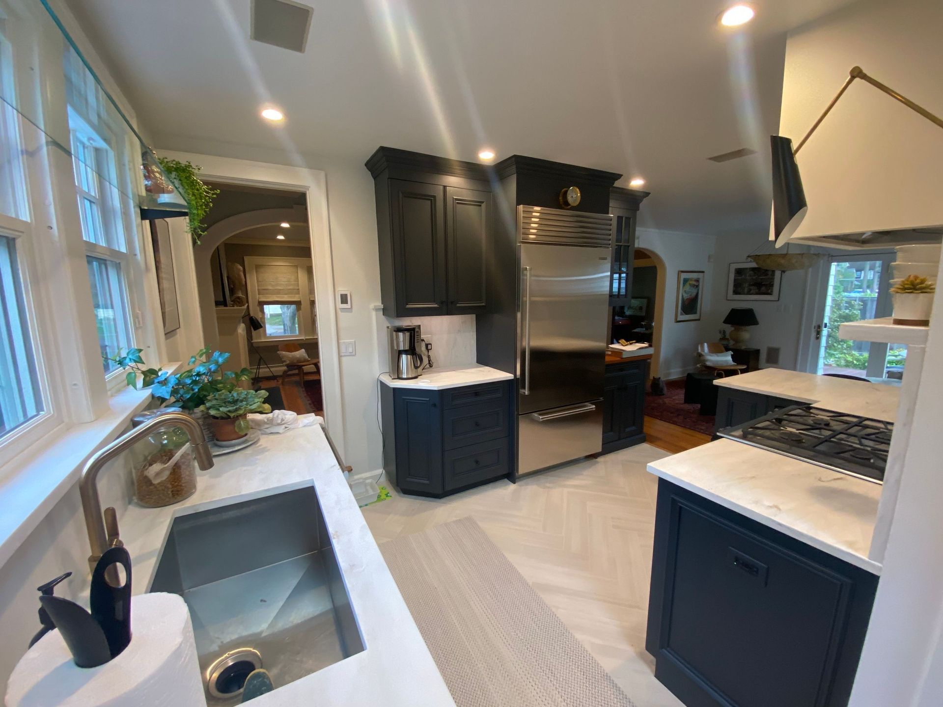 A kitchen with a sink , stove , refrigerator and dishwasher.