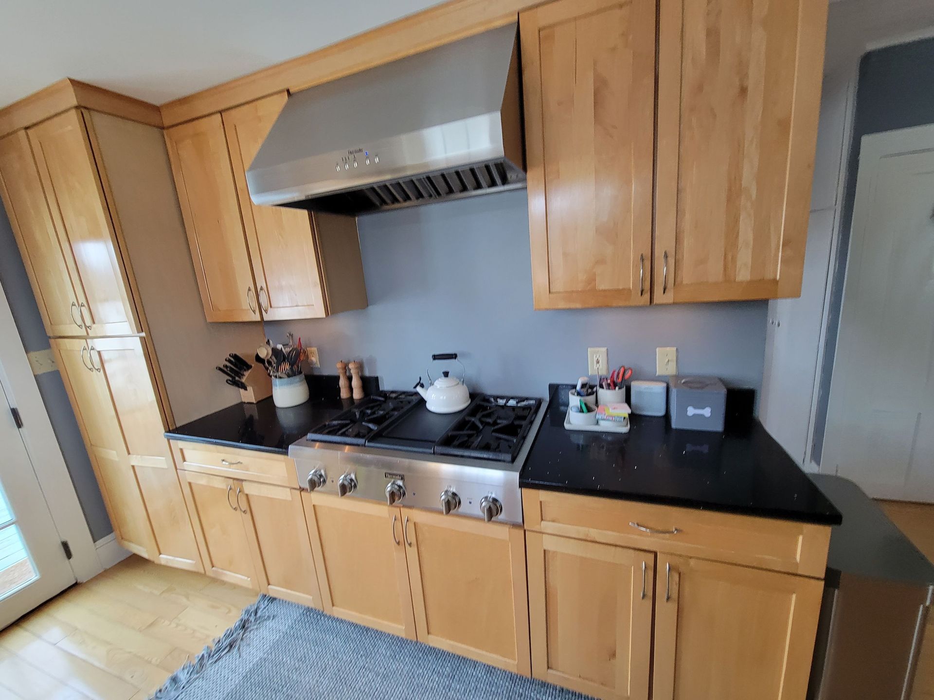 A kitchen with stainless steel appliances and wooden cabinets