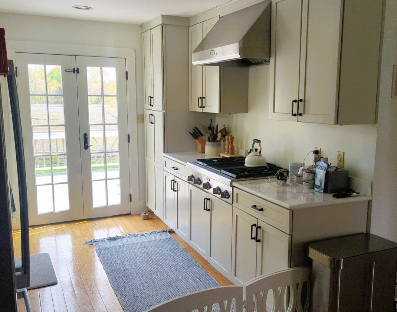 A kitchen with white cabinets and stainless steel appliances