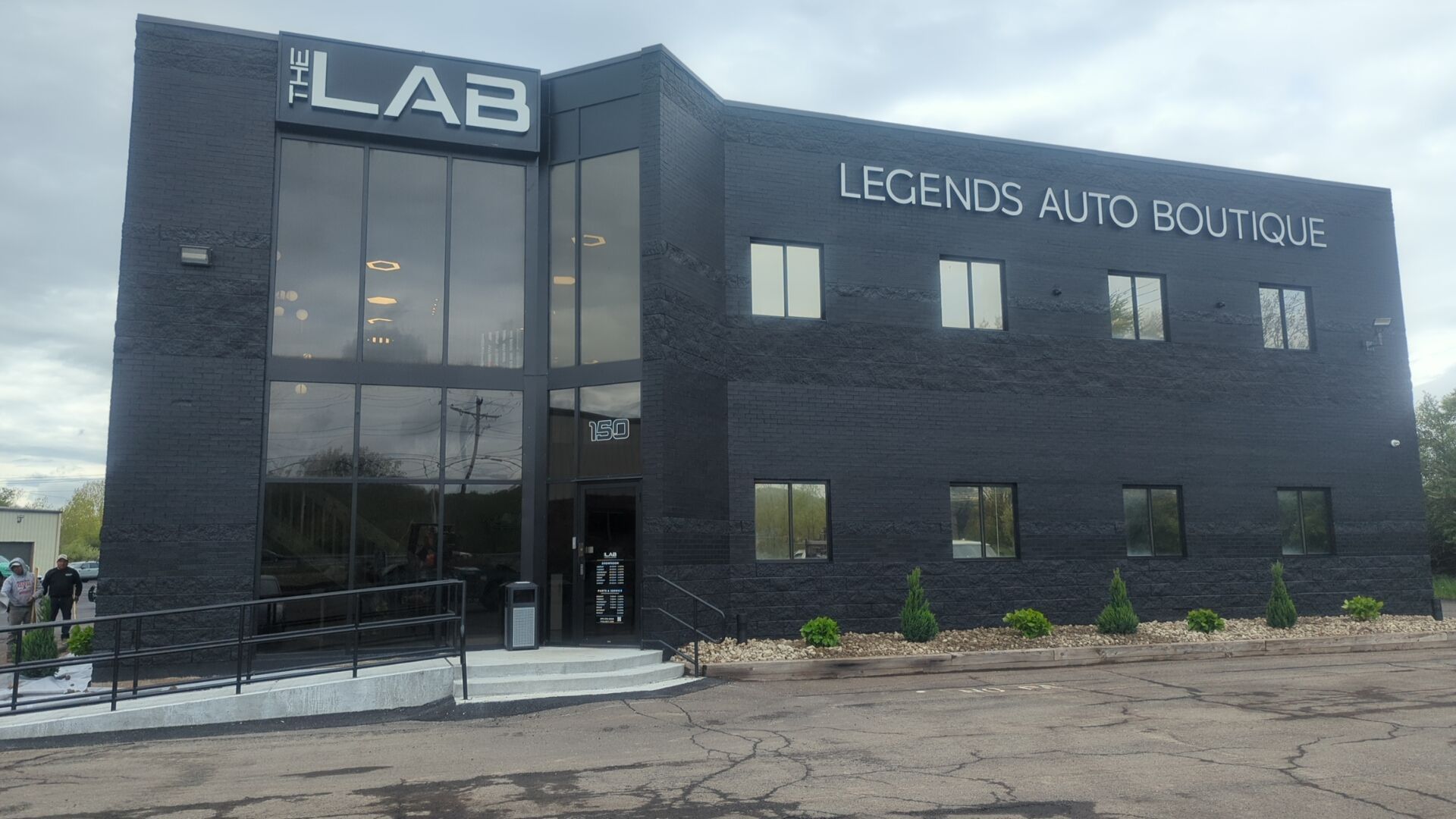 A large black building with legends auto boutique written on it