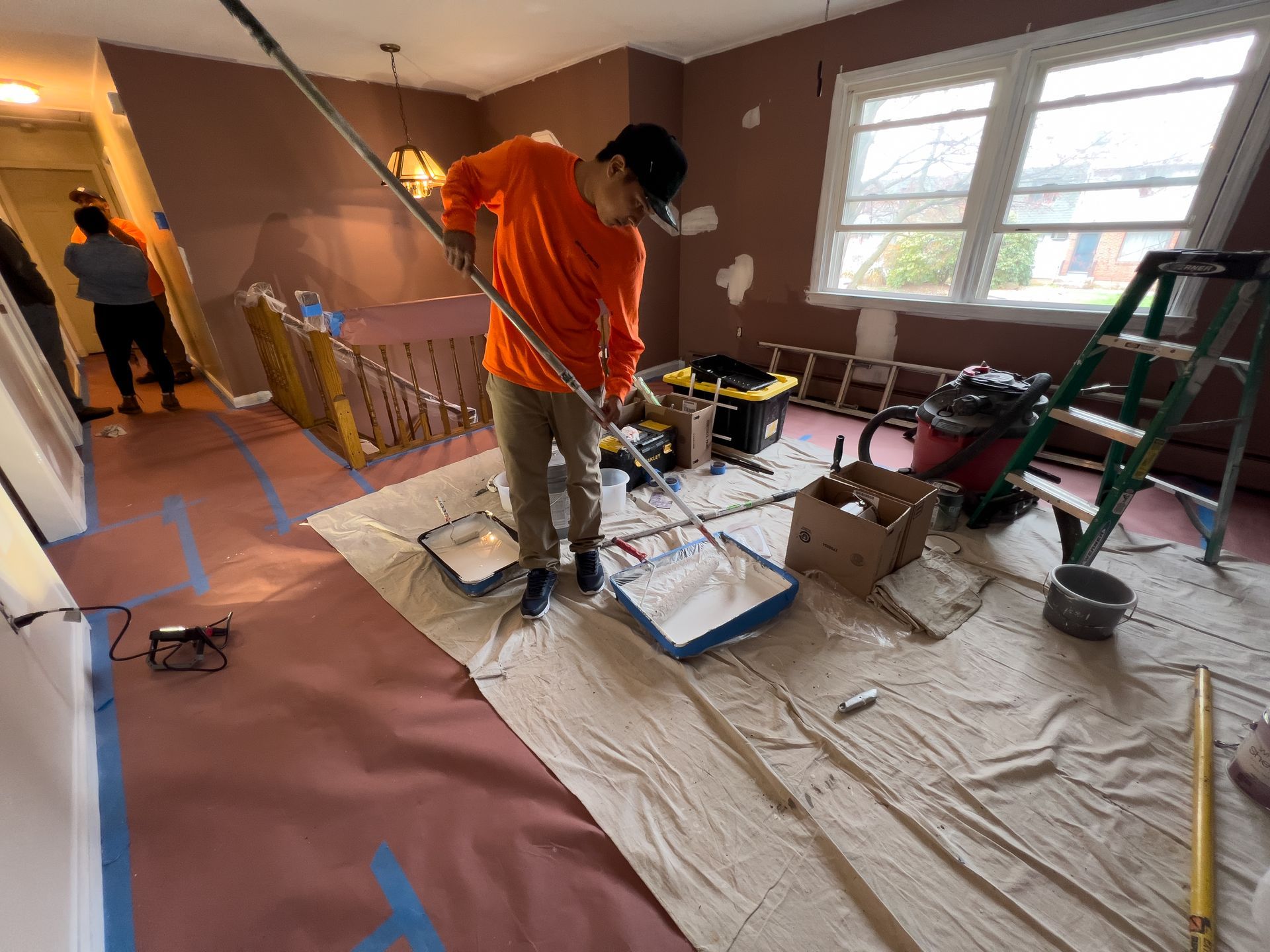 A man is painting a room in a house.