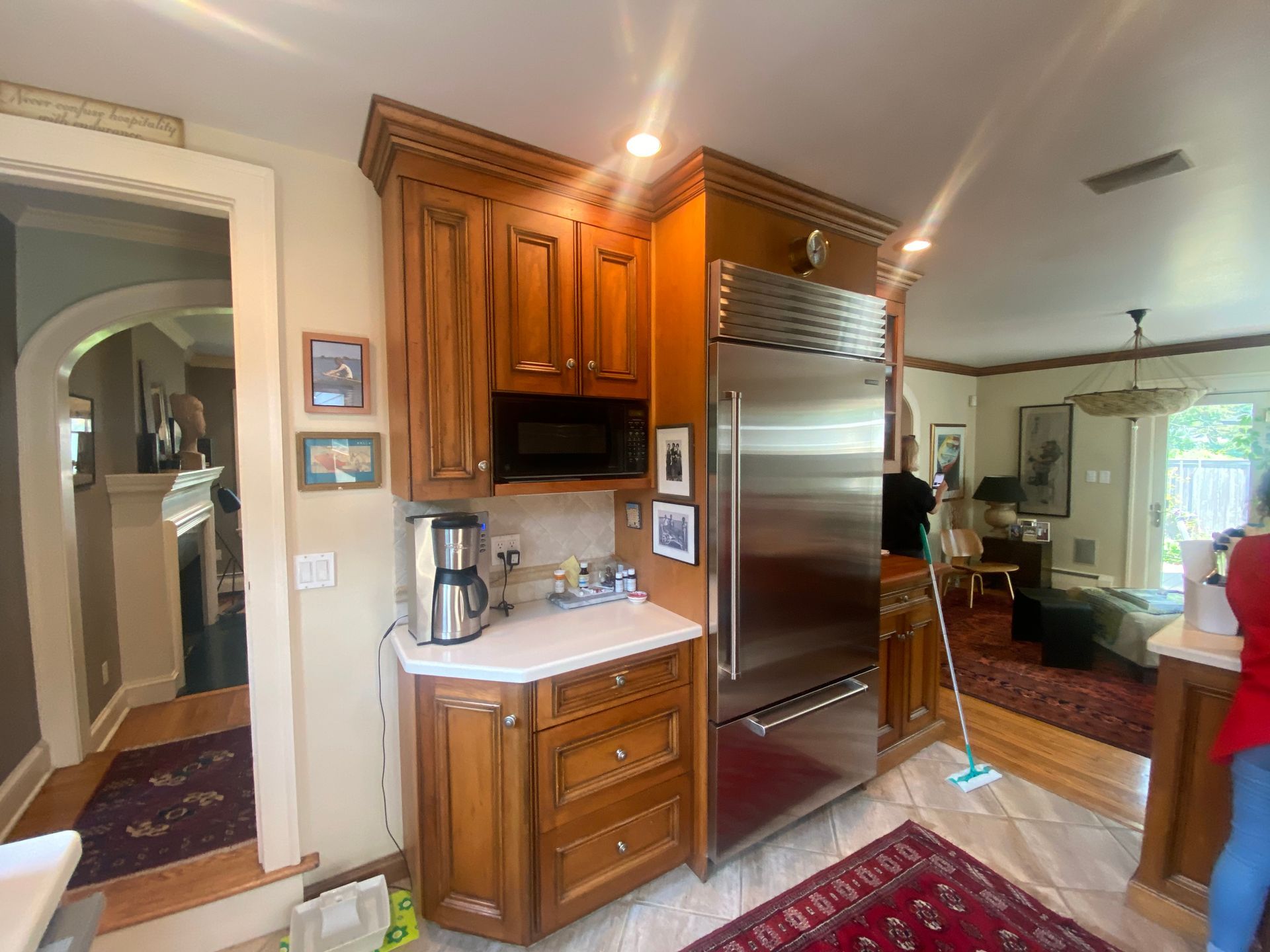 A kitchen with stainless steel appliances and wooden cabinets.