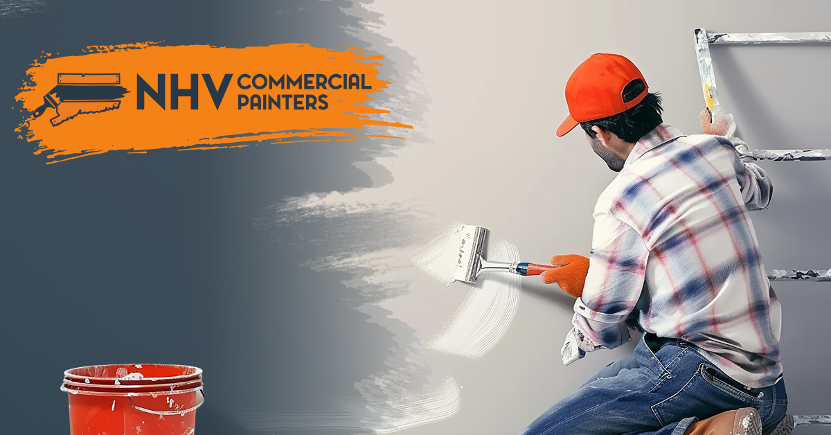 A painter in a plaid shirt and orange cap paints a wall white with a roller, with an NHV Commercial Painters logo above.