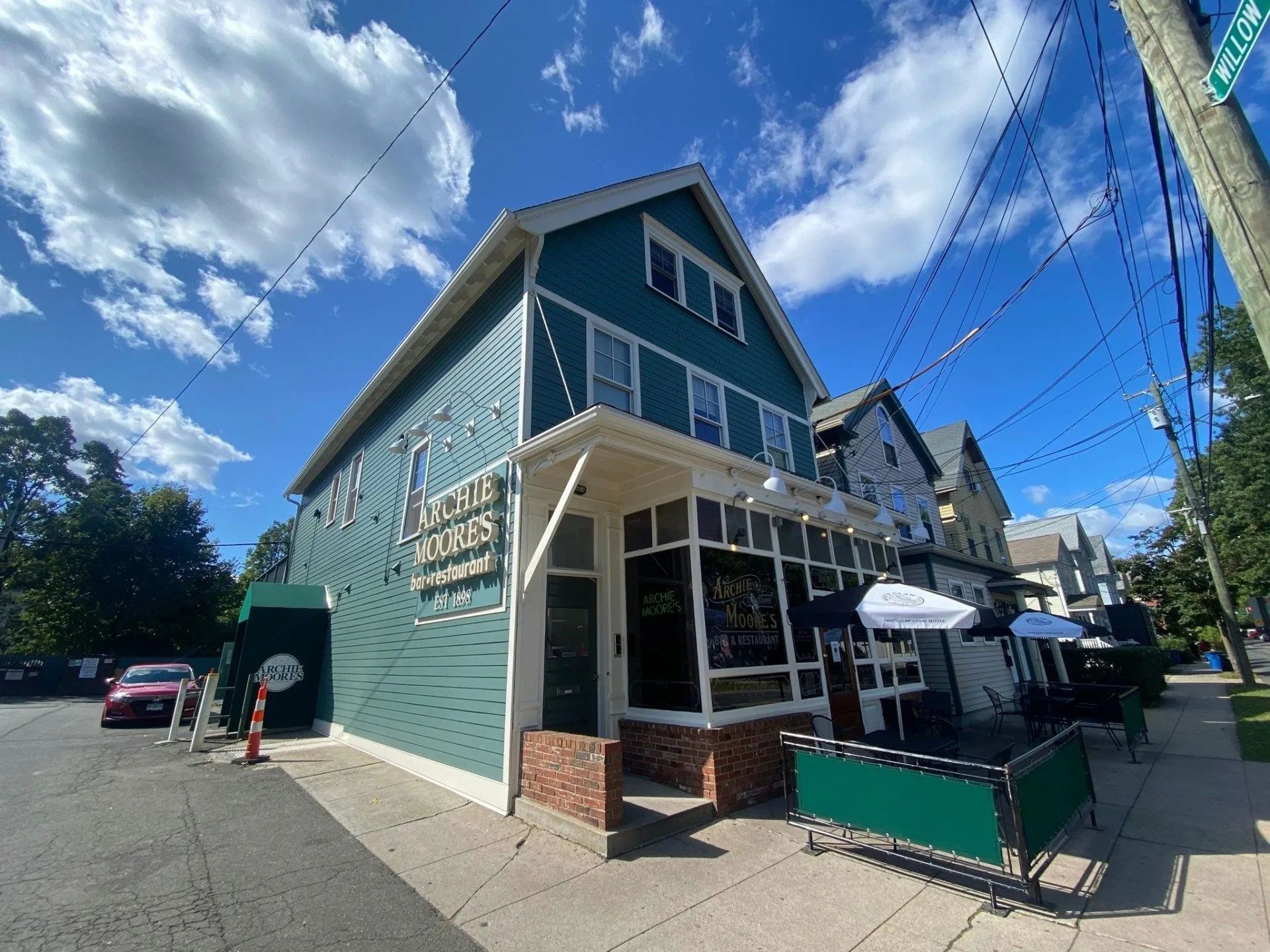A teal two-story building with a restaurant, 
