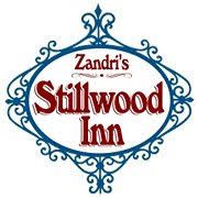 Logo for Zandri's Stillwood Inn: Oval blue frame with text and scrolls; red/brown