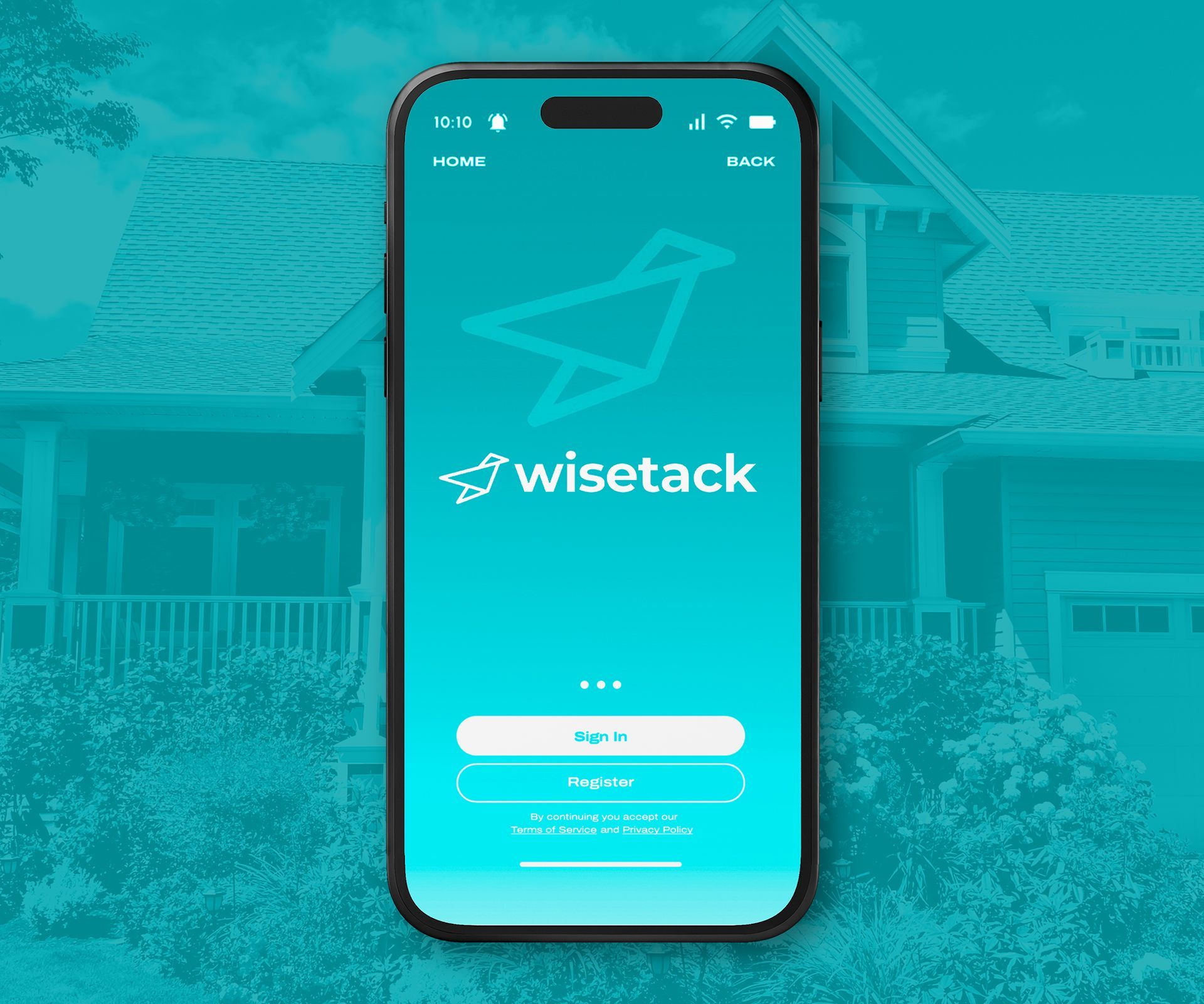 A phone with the wise tack app on it is sitting in front of a house.