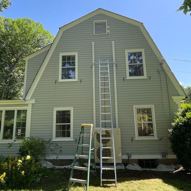 A house with a ladder on the side of it