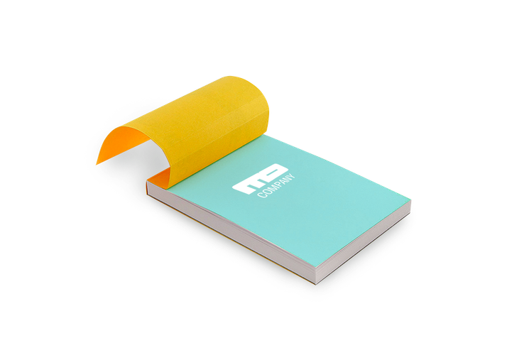 A small notepad with a turquoise cover and yellow binding, one page being peeled back.