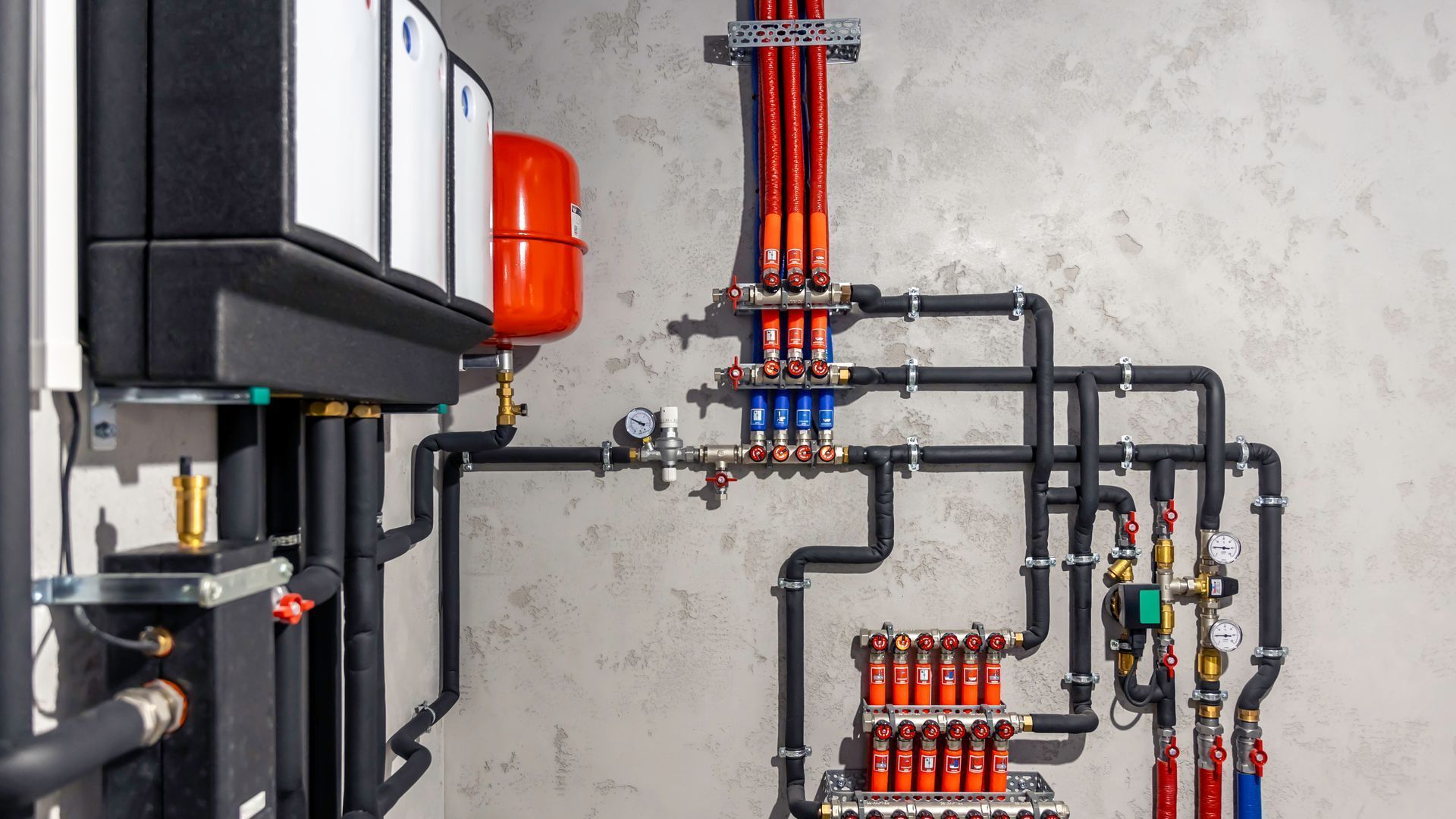 A room with a lot of pipes hanging from the ceiling.