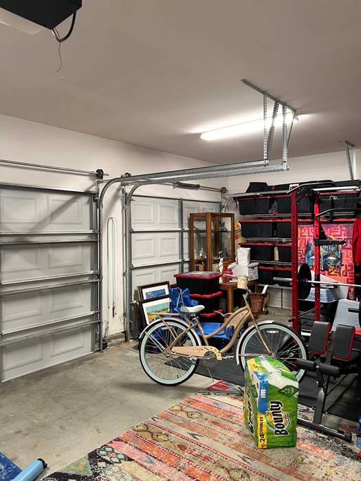 A garage filled with lots of toys and a treadmill.