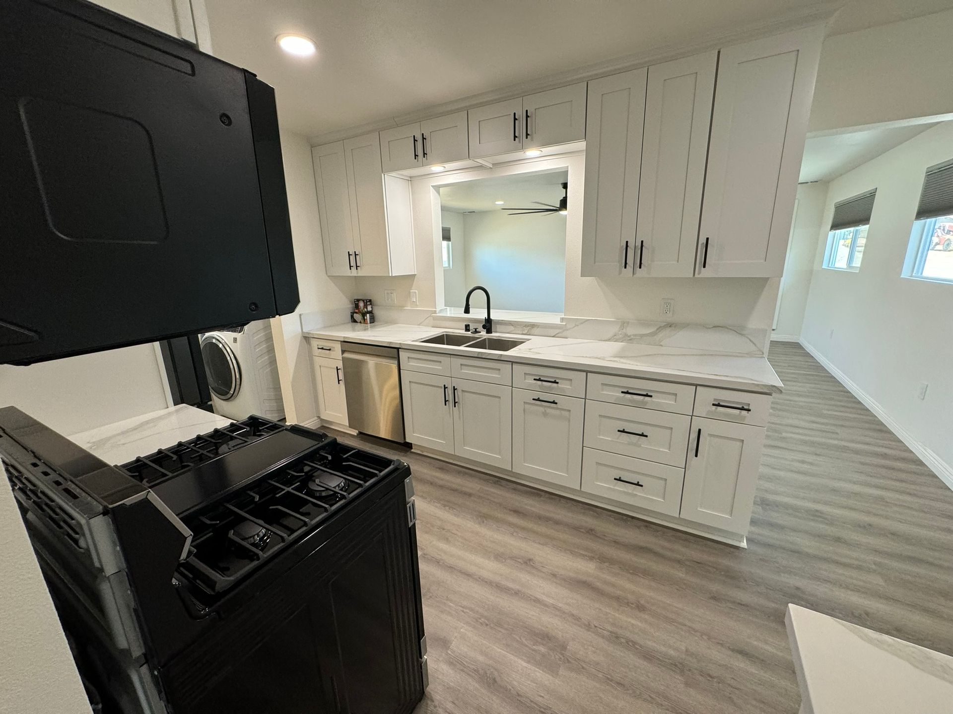 A kitchen with wooden cabinets and a brick wall.
