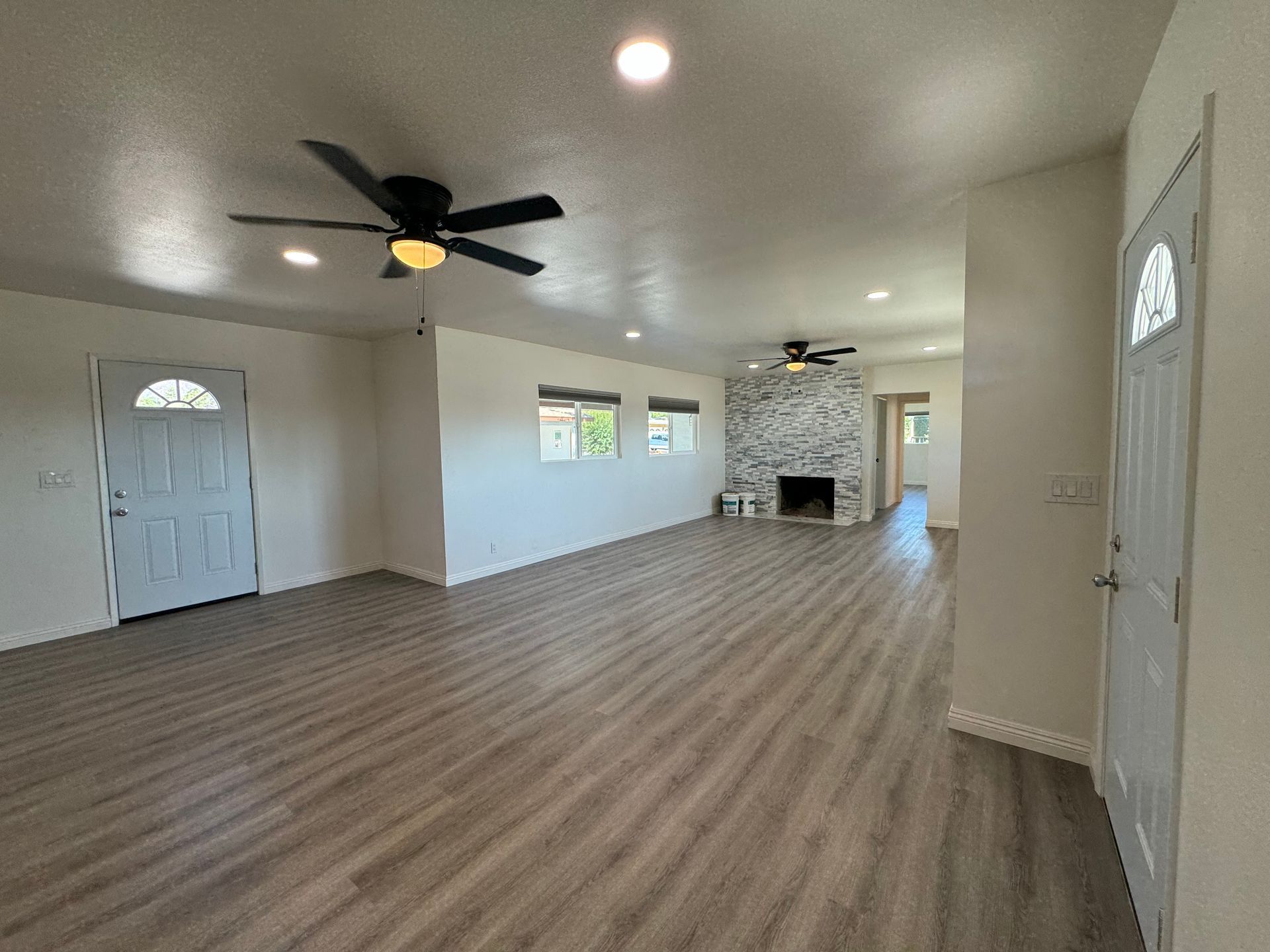 We took down the wall, replaced the old windows, gave the fireplace a facelift and installed new flooring.