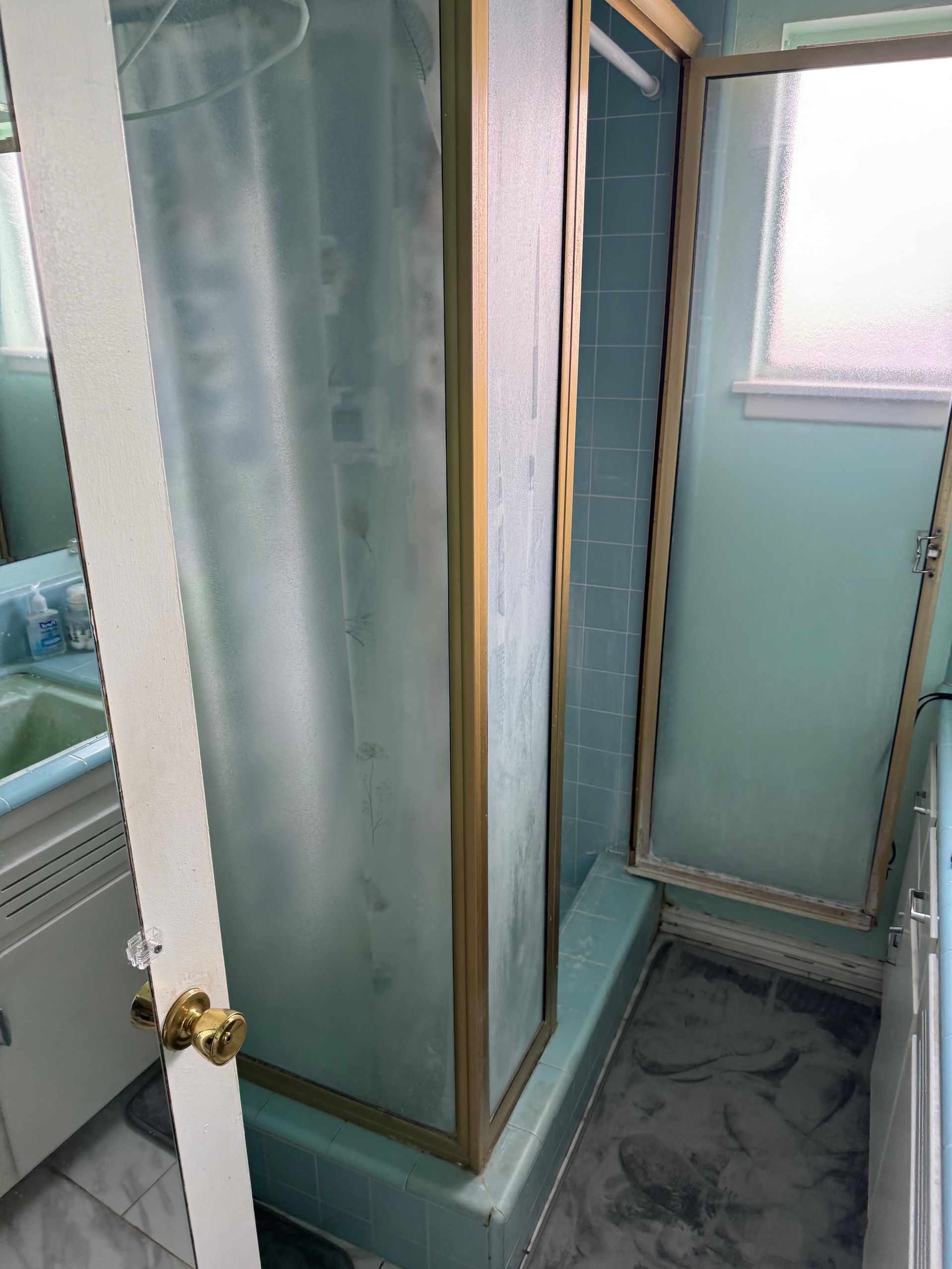 A closet with a staircase leading up to it and a window.