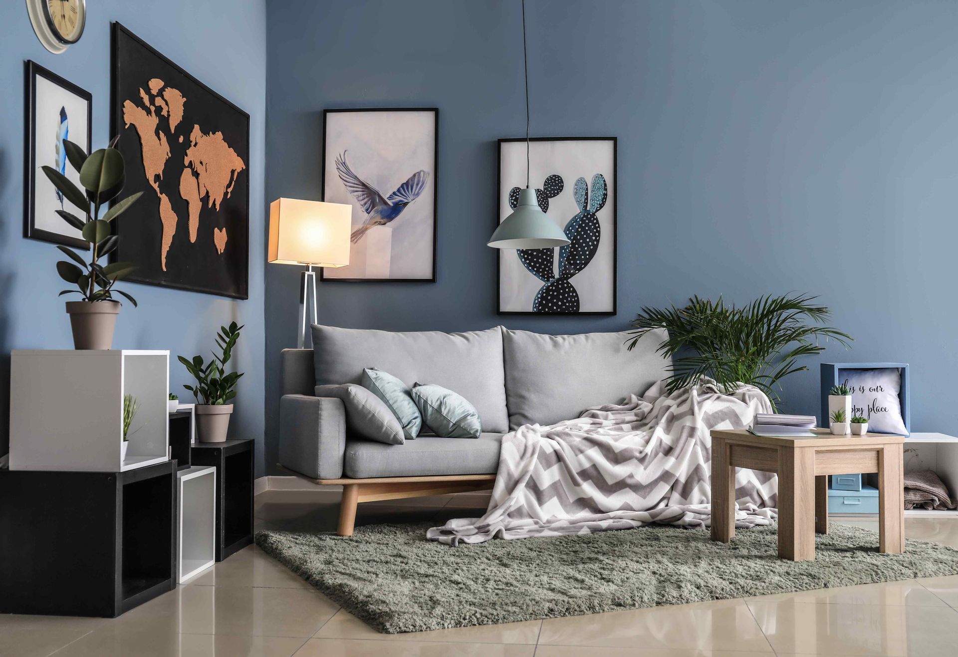 Bright kitchen with gray cabinets, white walls, wood ceiling, and chandeliers.