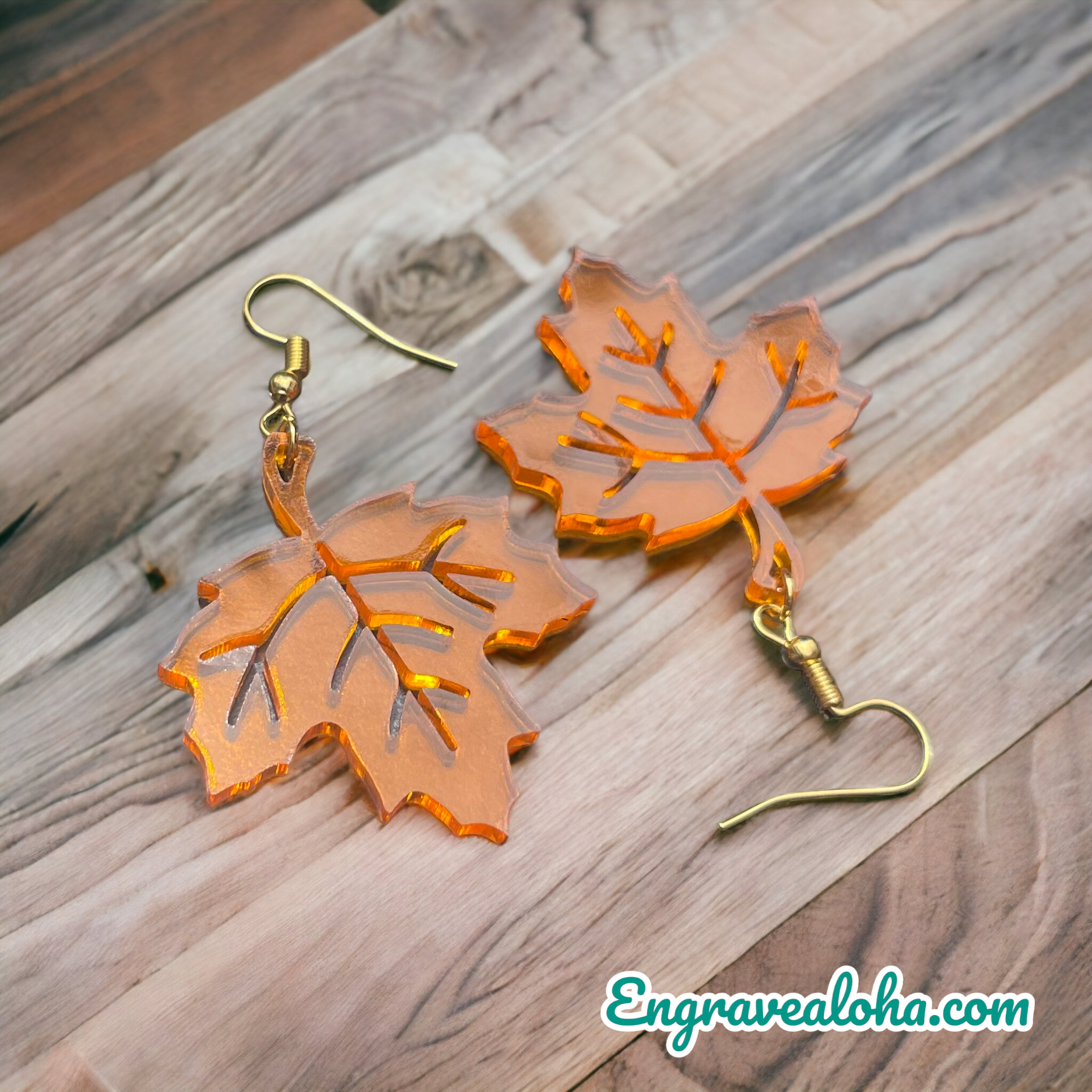 A pair of earrings made by engravealoha.com