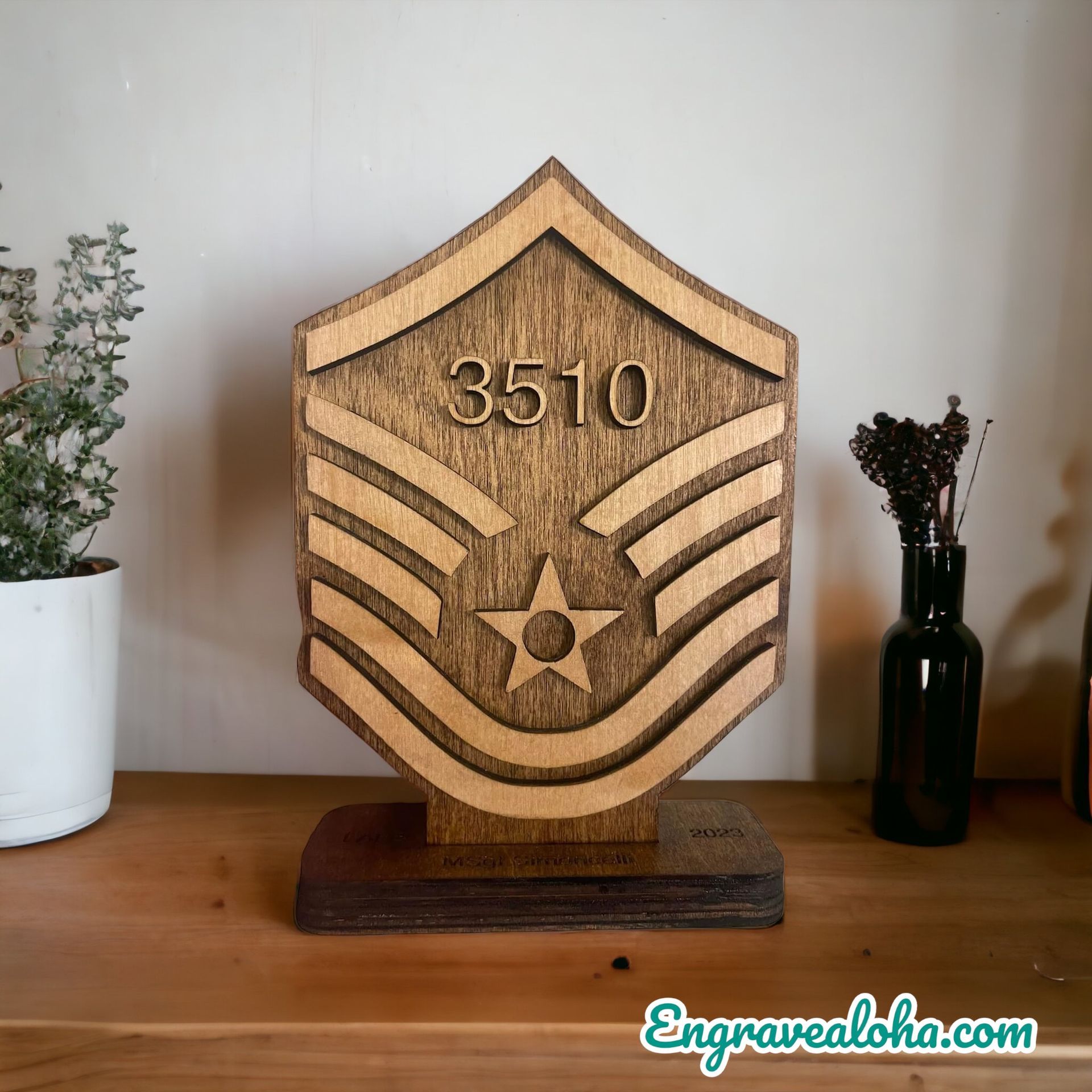 A wooden plaque with the number 3510 on it