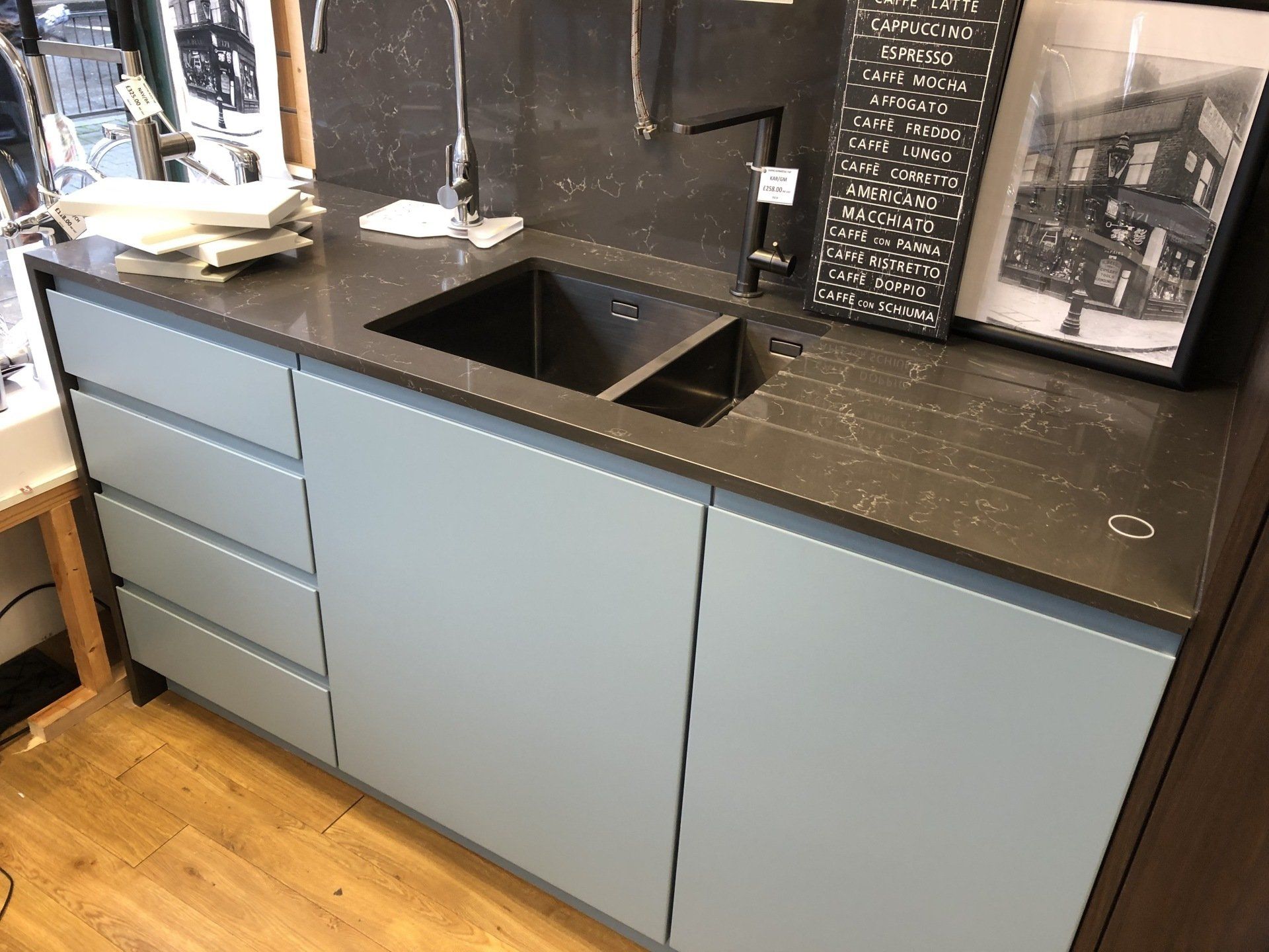 A modern kitchen featuring blue cabinets and a sleek sink